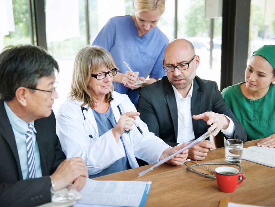 Business leader guiding a colleague during an office meeting.