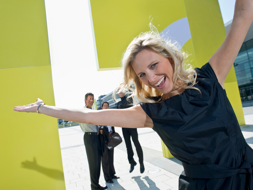 Woman celebrating what’s possible when operations run smoothly.